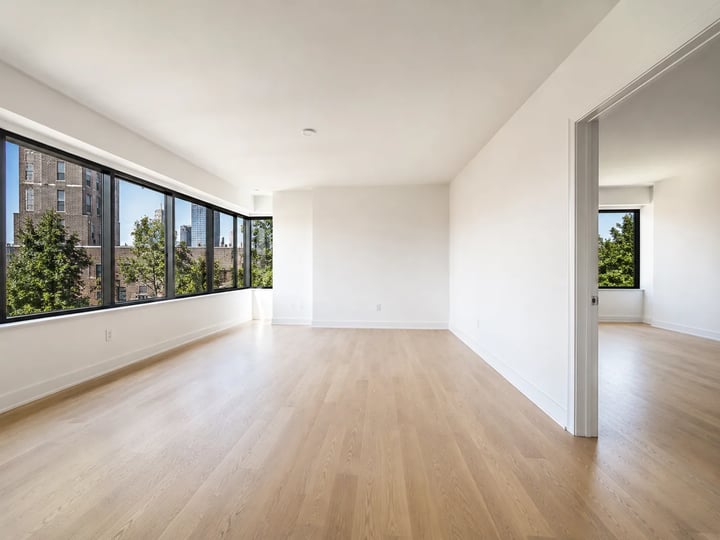 Empty living room with windows and bare floor